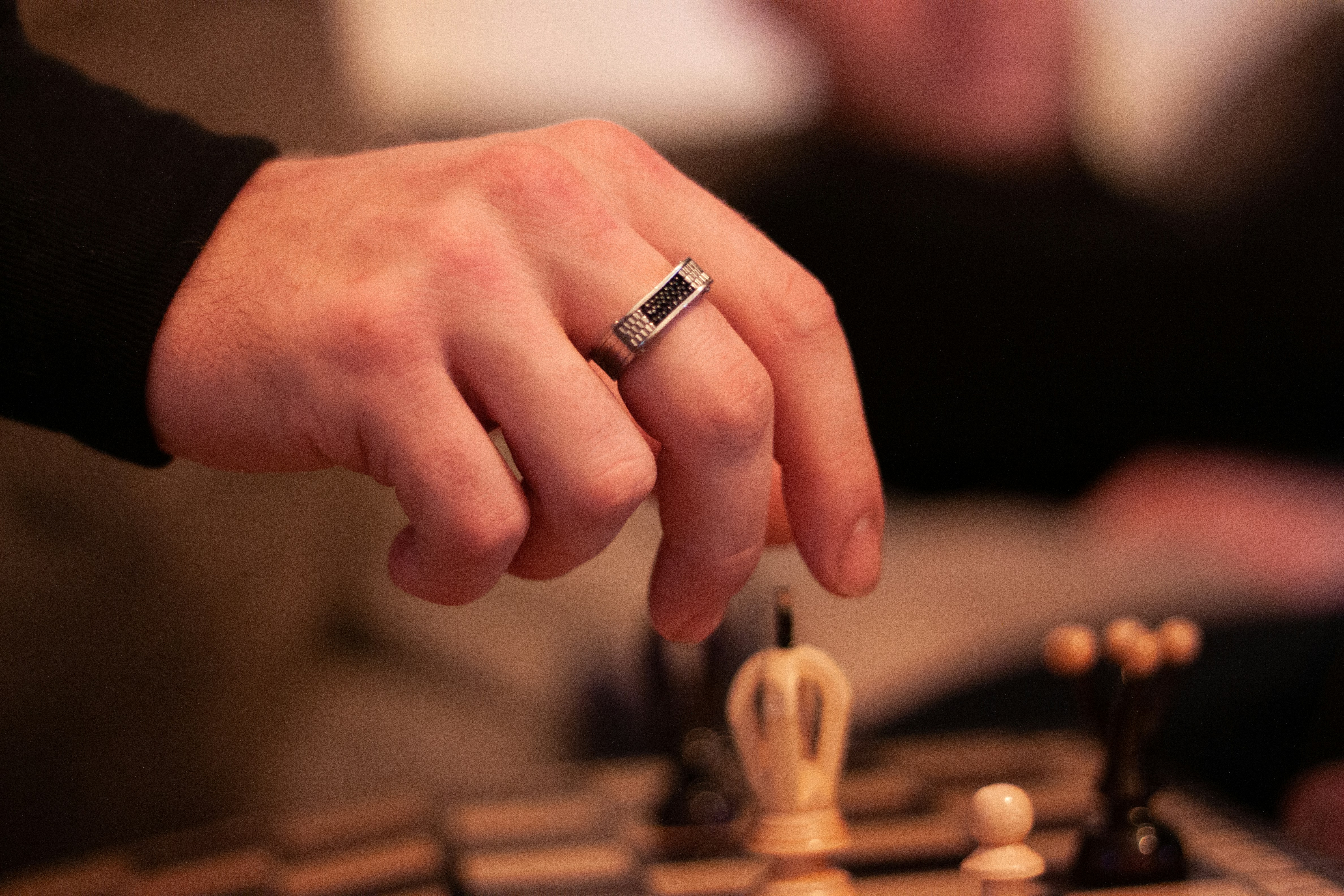 person wearing silver ring in tilt shift lens