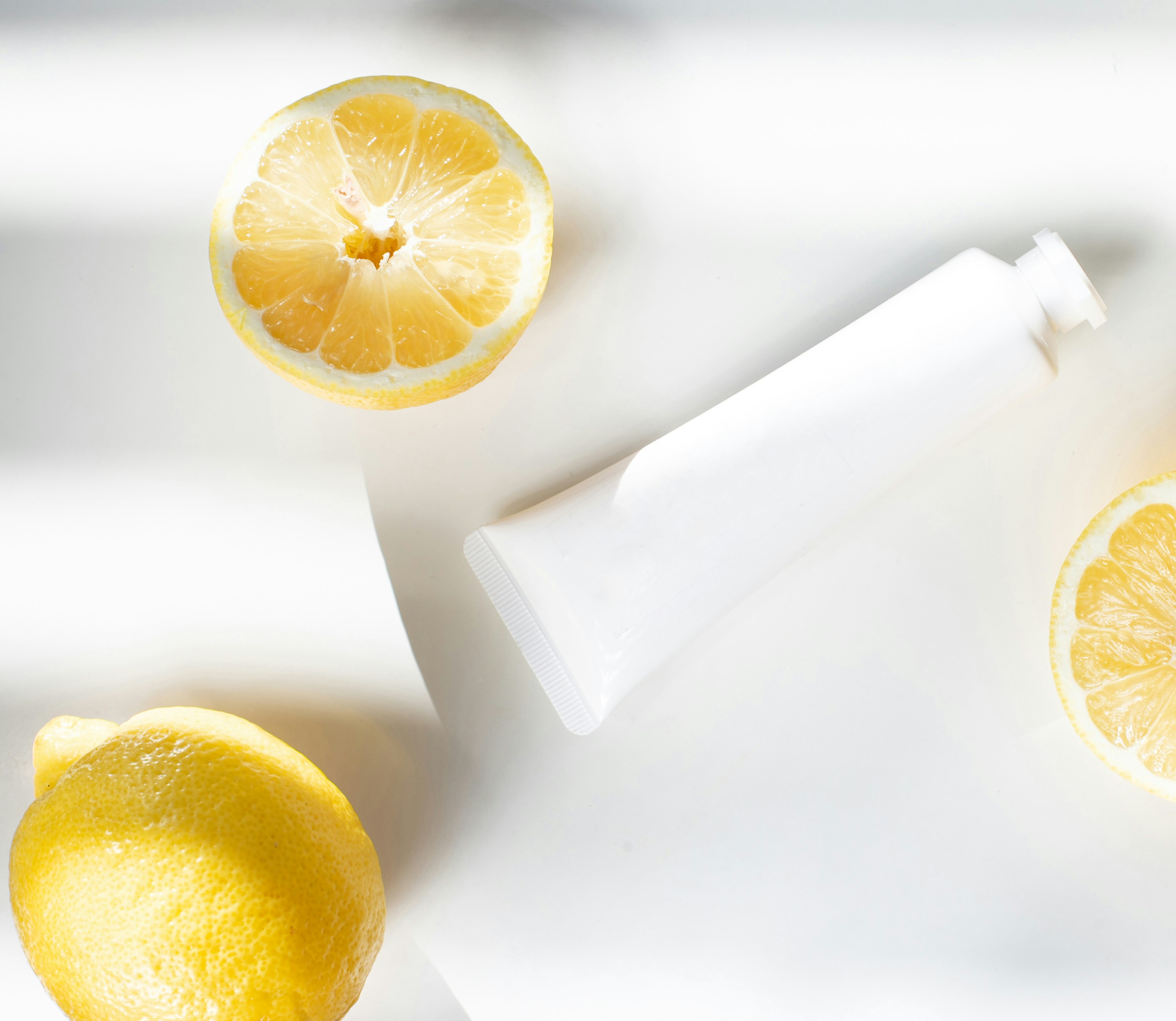 sliced lemon beside white ceramic container