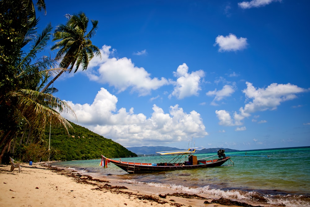 brown boat on shore during daytime