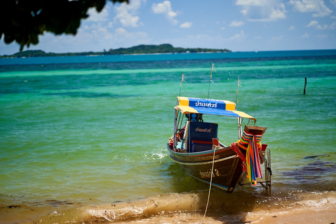 blue and white boat on sea during daytime