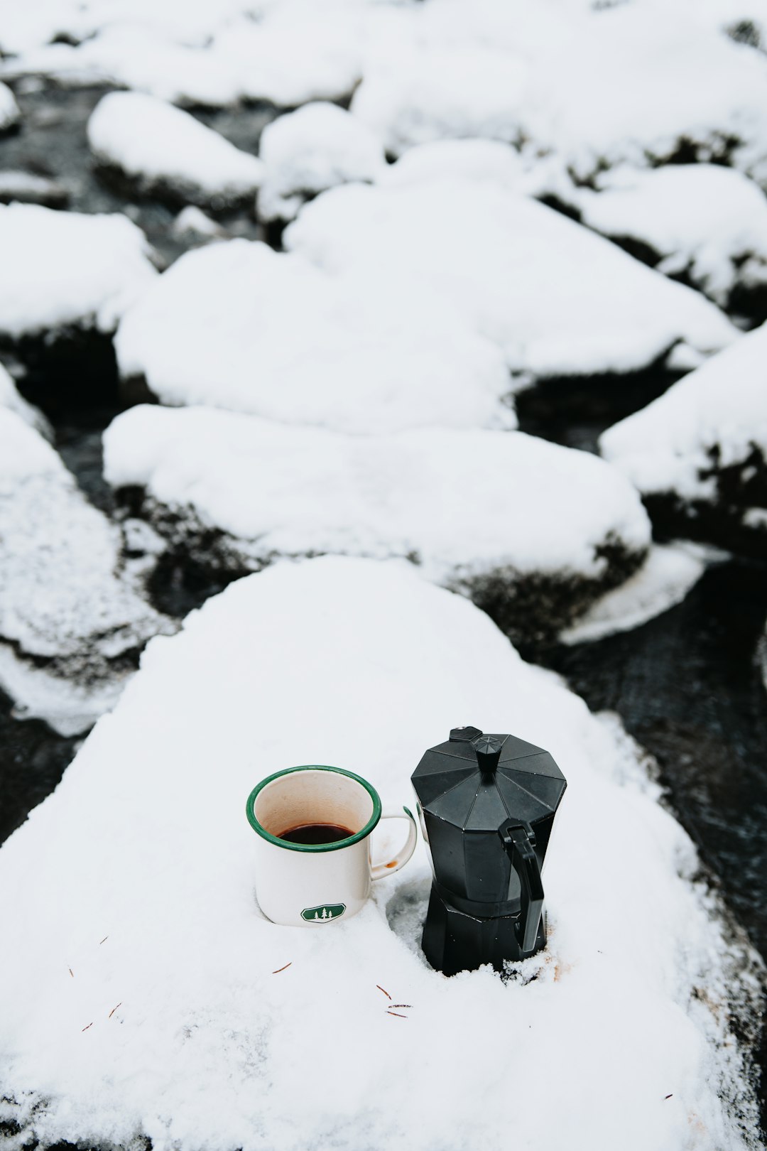 white ceramic mug on white snow