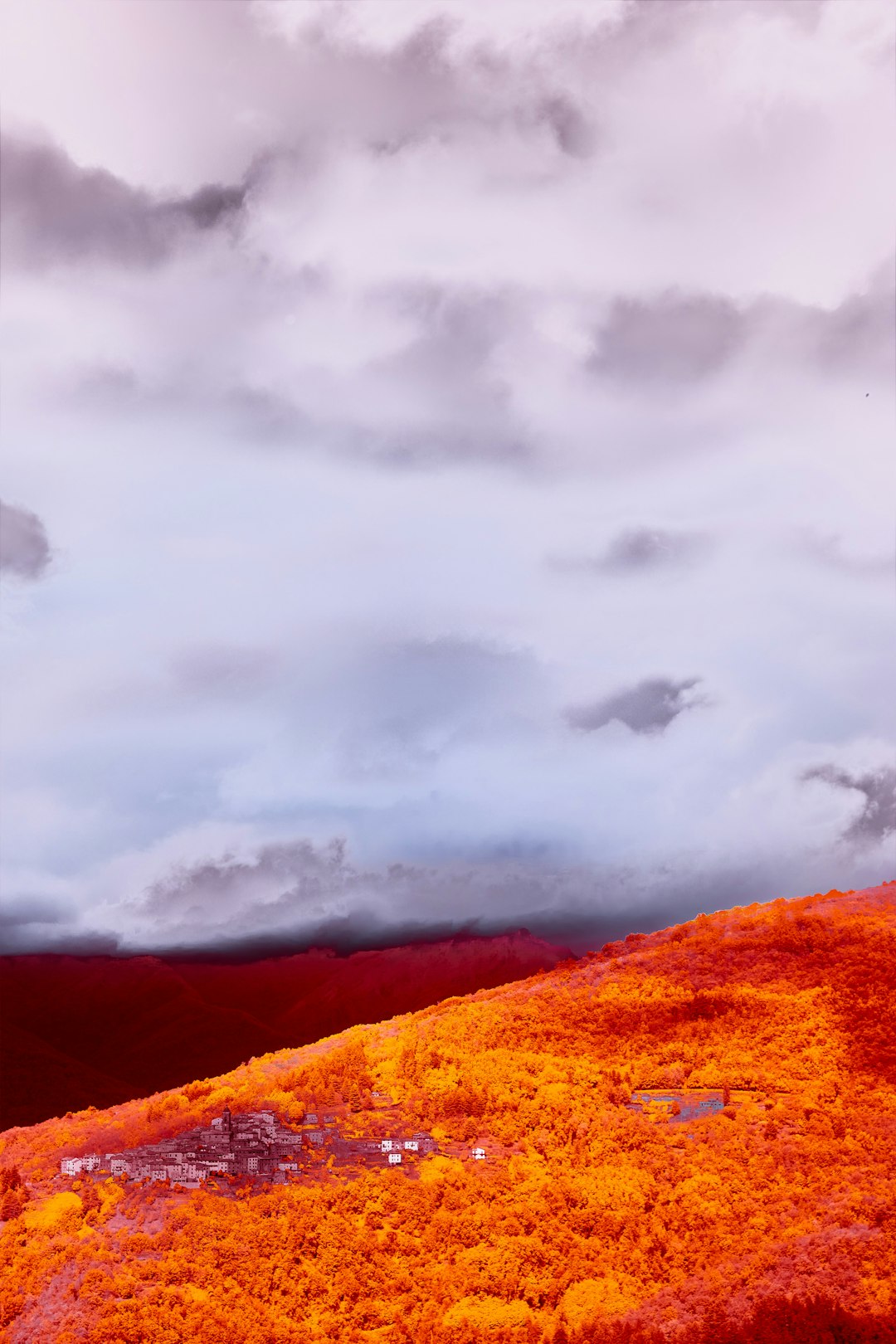 brown and gray mountain under gray clouds