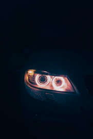 Close-up of a bright automotive halogen lamp glowing against a dark background