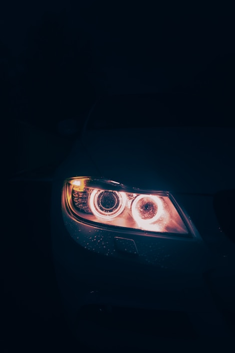 Close-up of a bright automotive halogen lamp glowing against a dark background