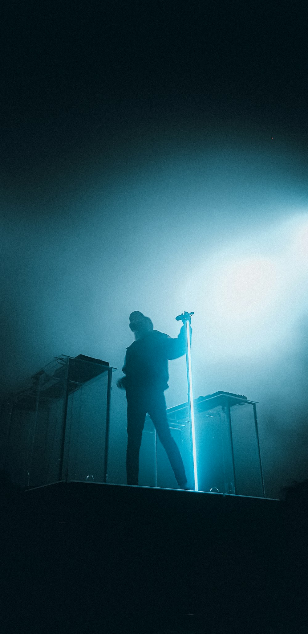 man in black jacket standing on stage