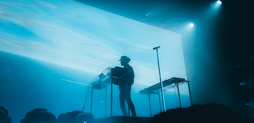 silhouette of man standing on the ladder