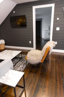 white fur textile on brown wooden chair