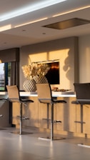black and silver chair beside black flat screen tv