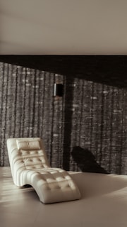 Cozy linen chaise lounge placed near a sunlit window with a minimalistic modern vibe