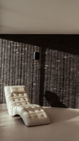 A classic chaise lounge with renewed padding and a soft, textured fabric in warm tones.