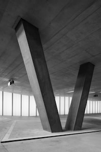 grayscale photo of man walking on hallway