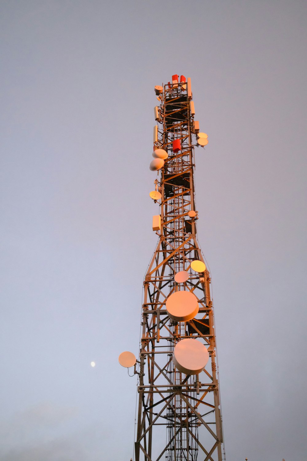 orange and black tower under gray sky