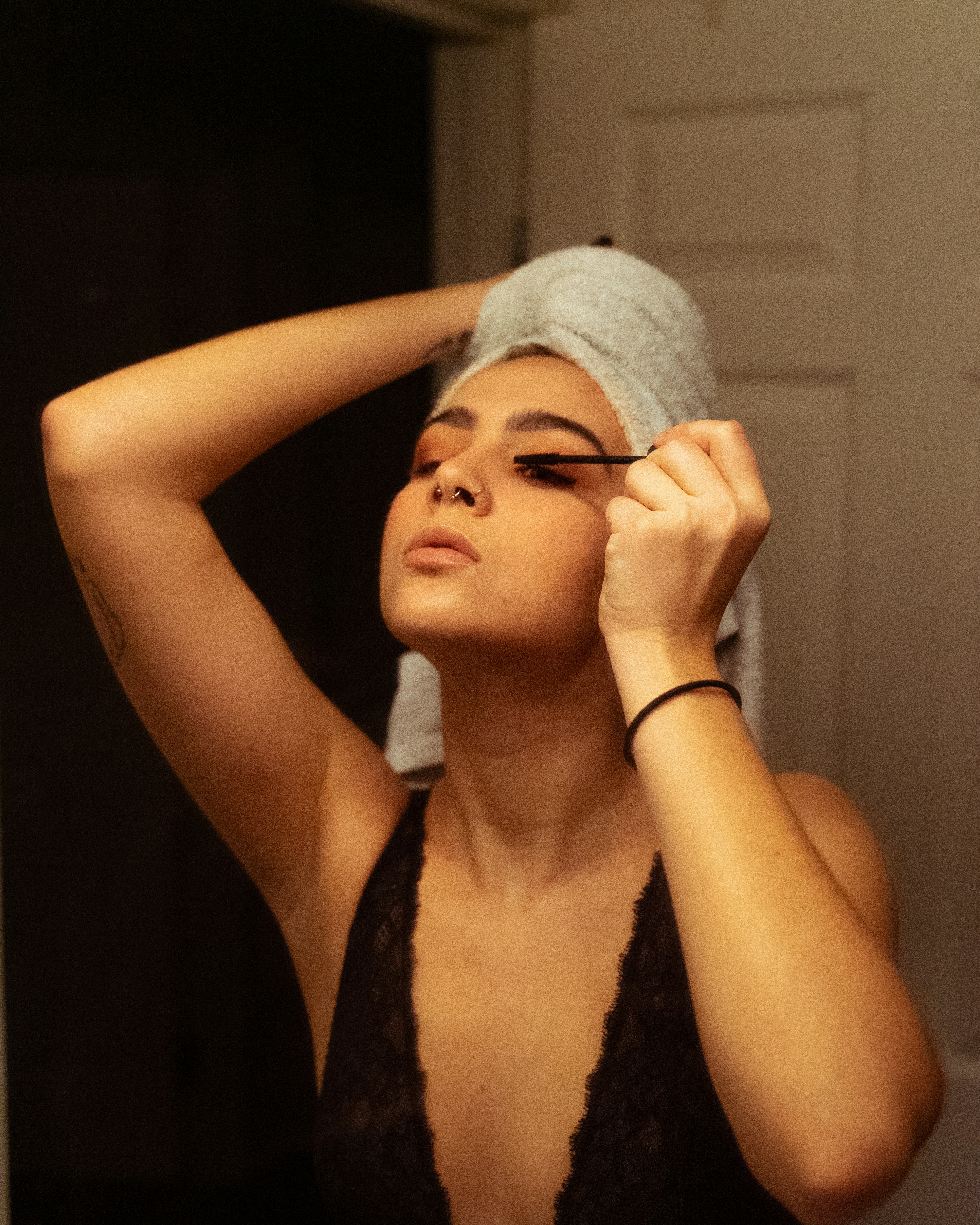 woman in black tank top with blue towel on her head