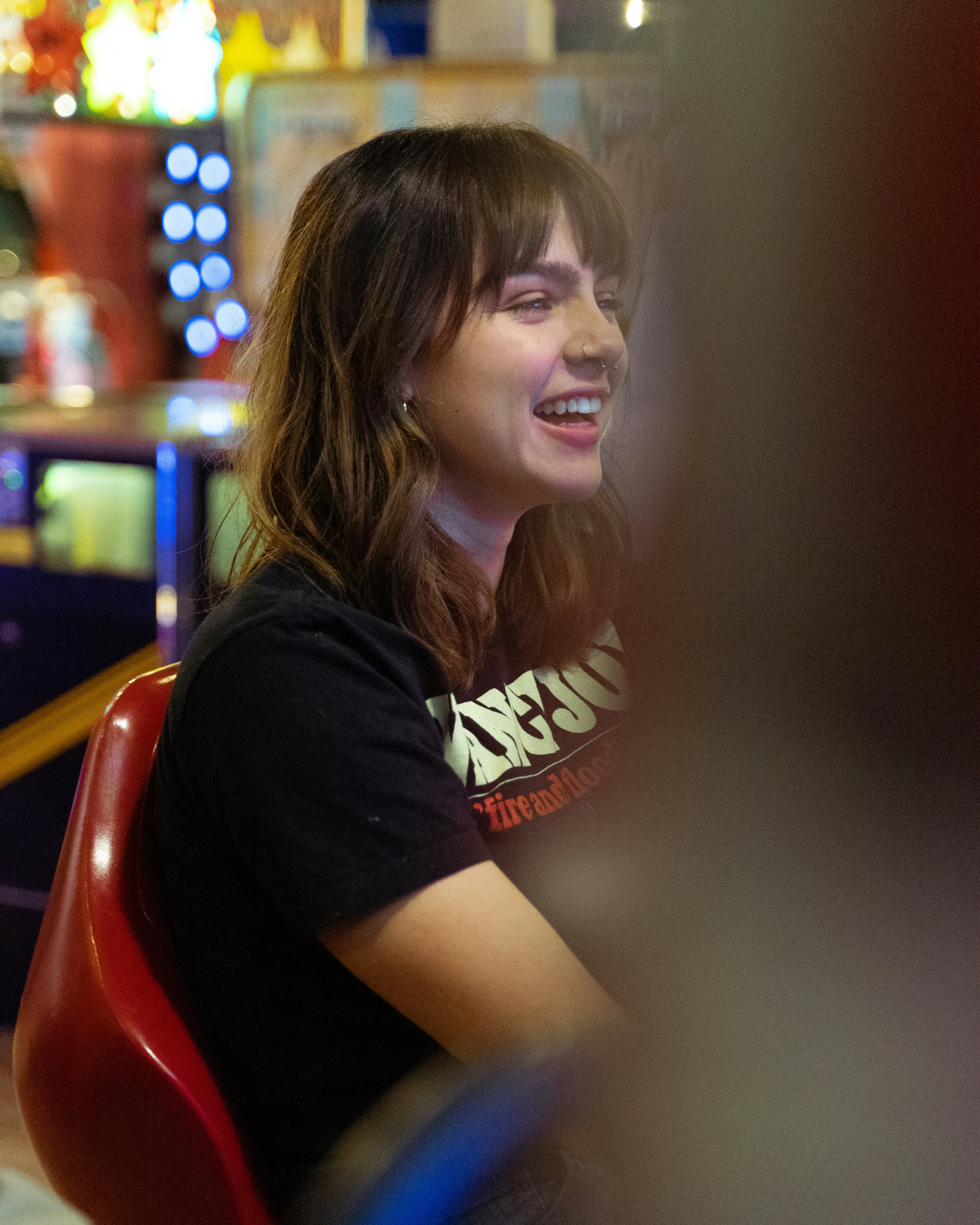 woman in black t-shirt sitting on red chair