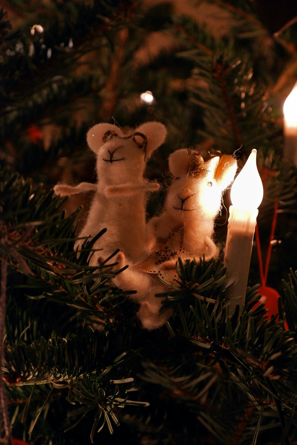 white ceramic cat figurine on green christmas tree