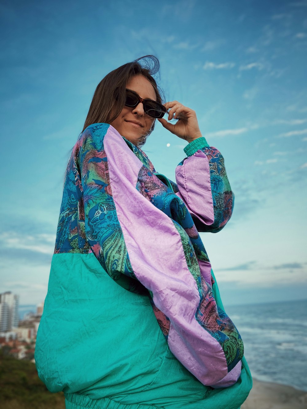 woman in green and pink floral long sleeve shirt and green pants wearing black sunglasses