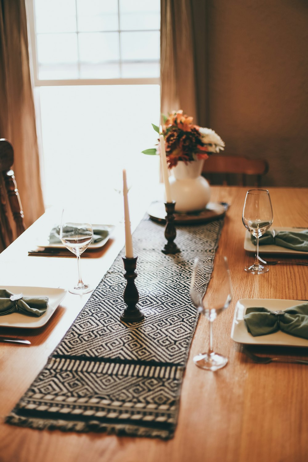 white and black candle holder on table