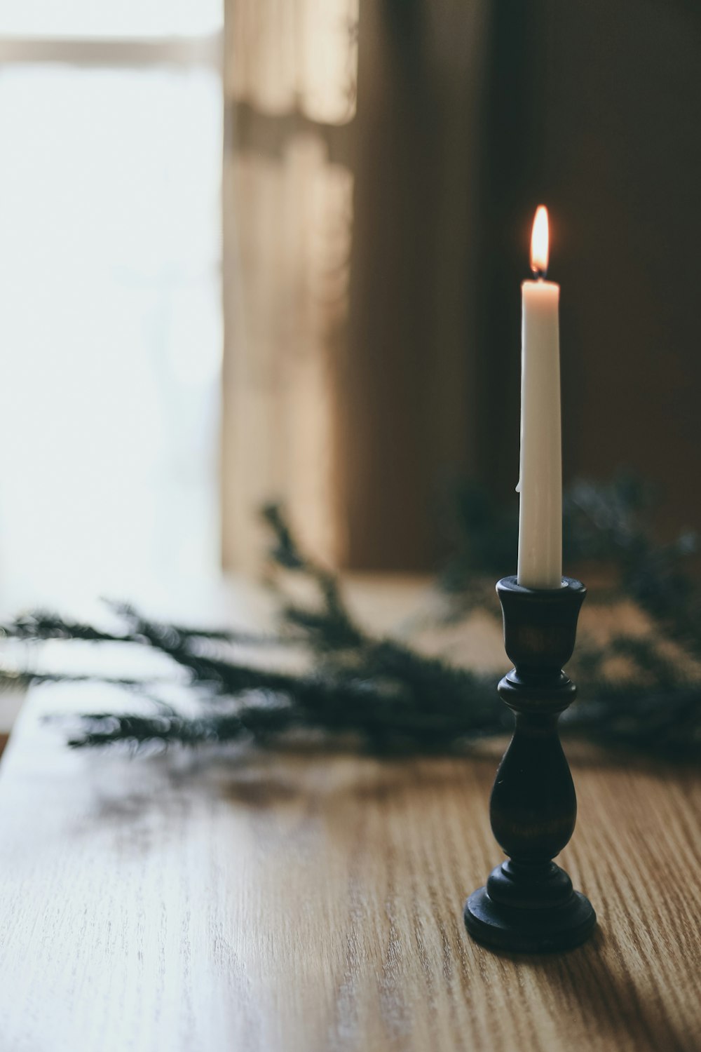 white candle on black candle holder