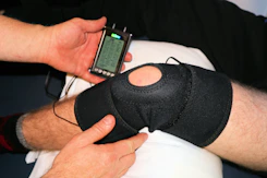 Orthopedic specialists examining patient with supportive braces in a well-equipped clinic.