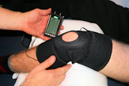 A caring orthopedic specialist assisting a patient during rehabilitation in a modern clinic setting