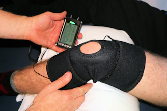 Close-up of the glokore knee massager wrapped comfortably around a bent knee.