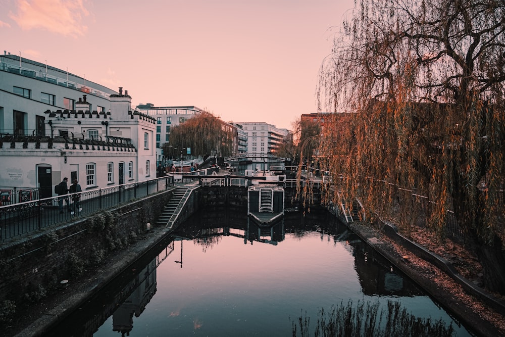 white and brown concrete building beside river during daytime