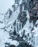 snow covered rock during daytime