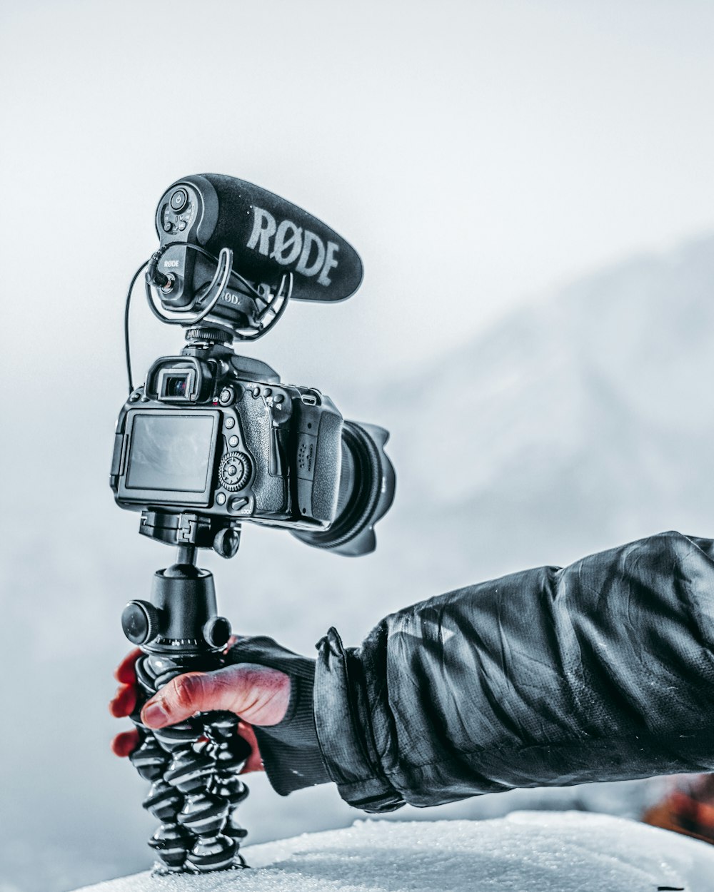 black and red motorcycle with black and gray camera