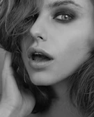 Black and white close-up of a model's expressive eyes and subtle makeup