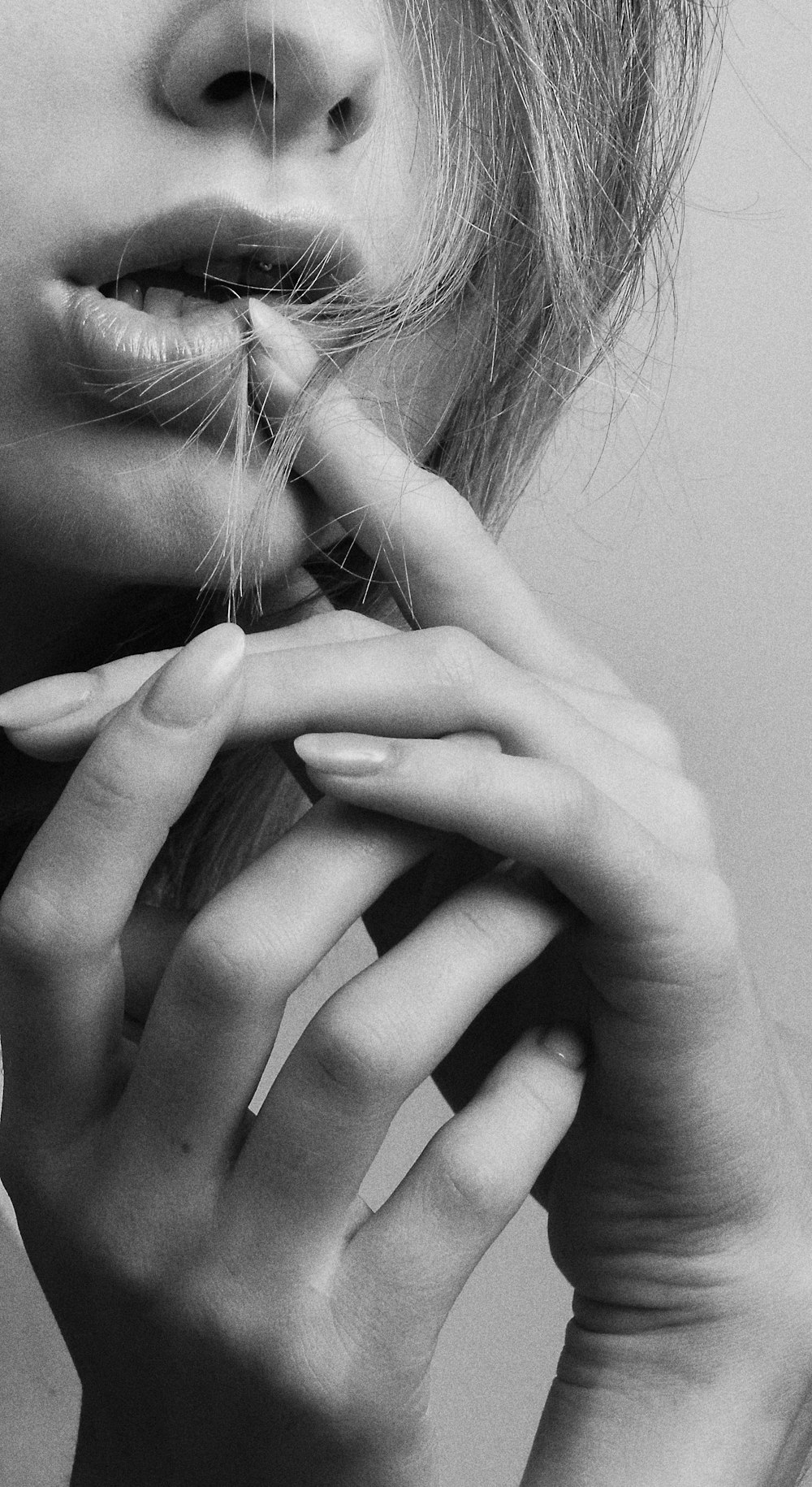 grayscale photo of woman covering her face