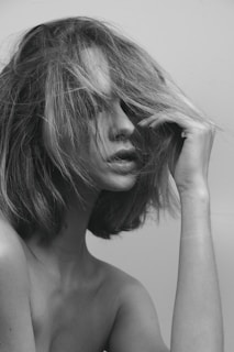 Minimalist noir-style portrait of a woman deep in thought, embodying the journey from head to action.