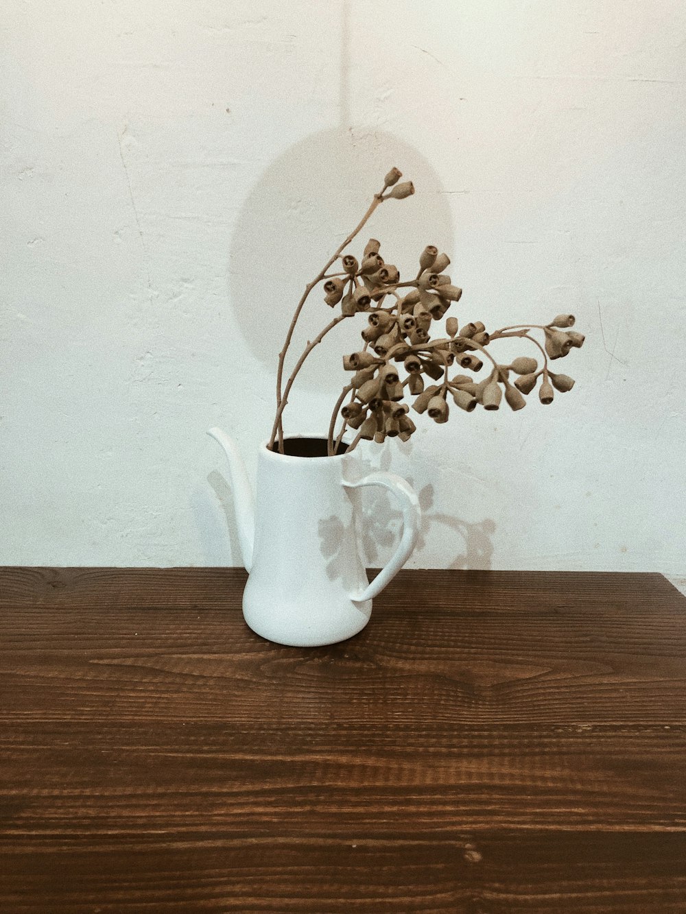 white ceramic mug on brown wooden table