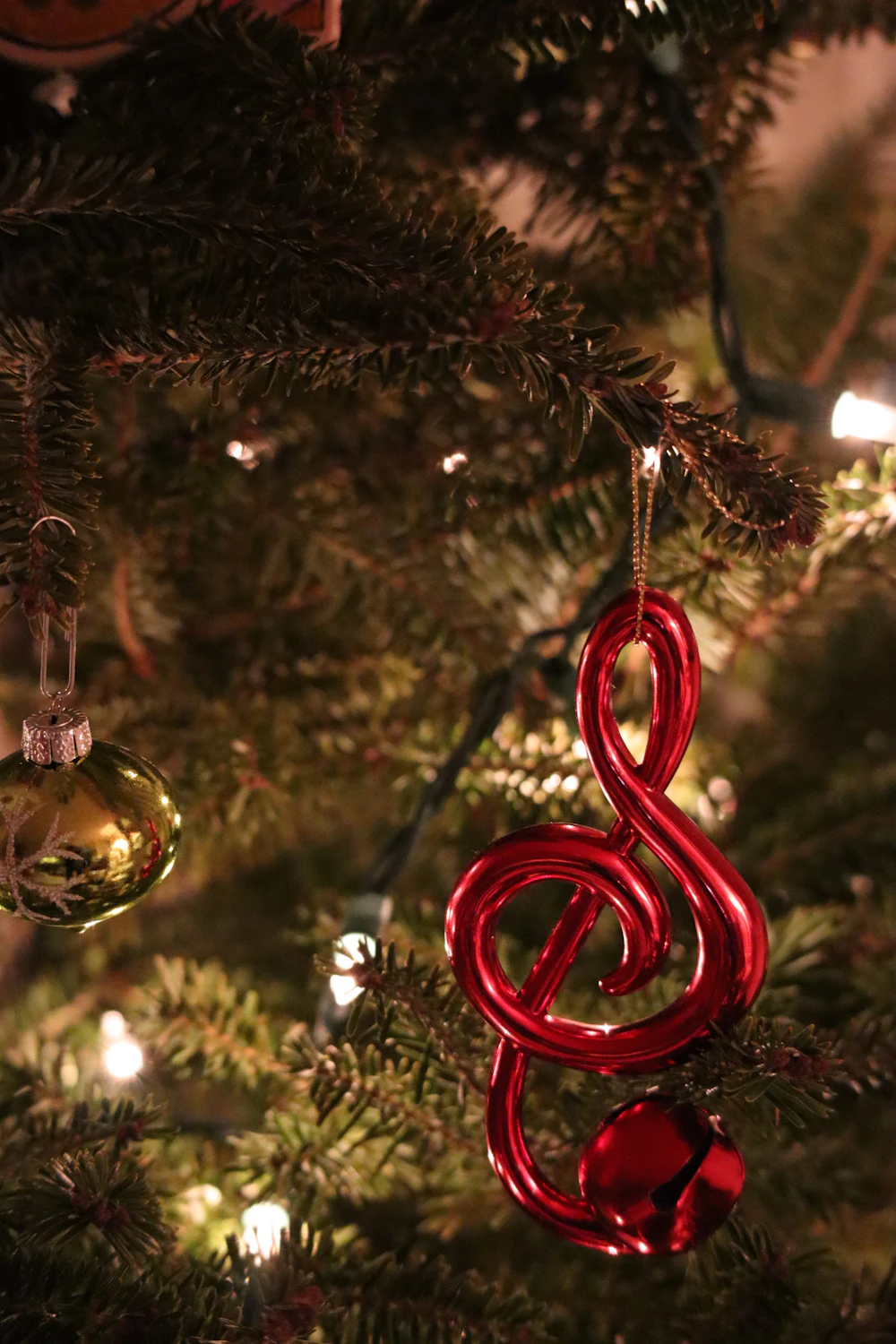 Red and gold decorative holiday baubles arranged together as seasonal ornaments