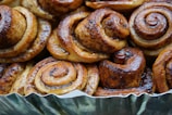 Close-up of a freshly baked cinnamon roll with golden glaze.