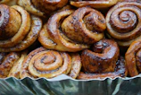 Close-up of golden brown cinnamon rolls with a glossy glaze.