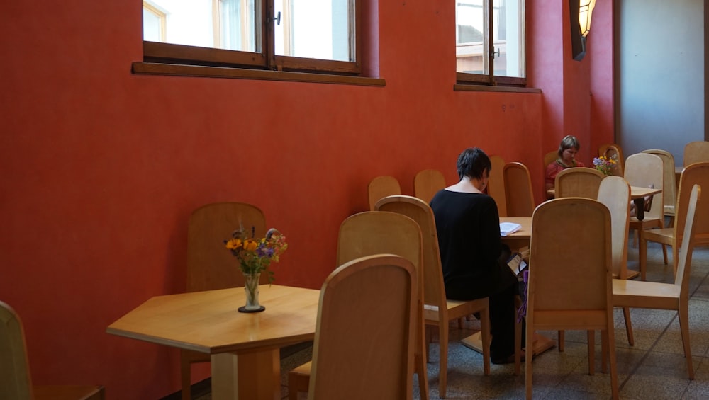 man in black shirt sitting on chair