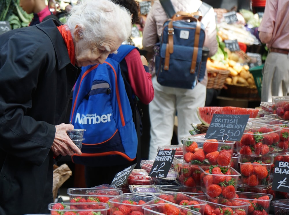 man in blue jacket standing beside woman in blue jacket