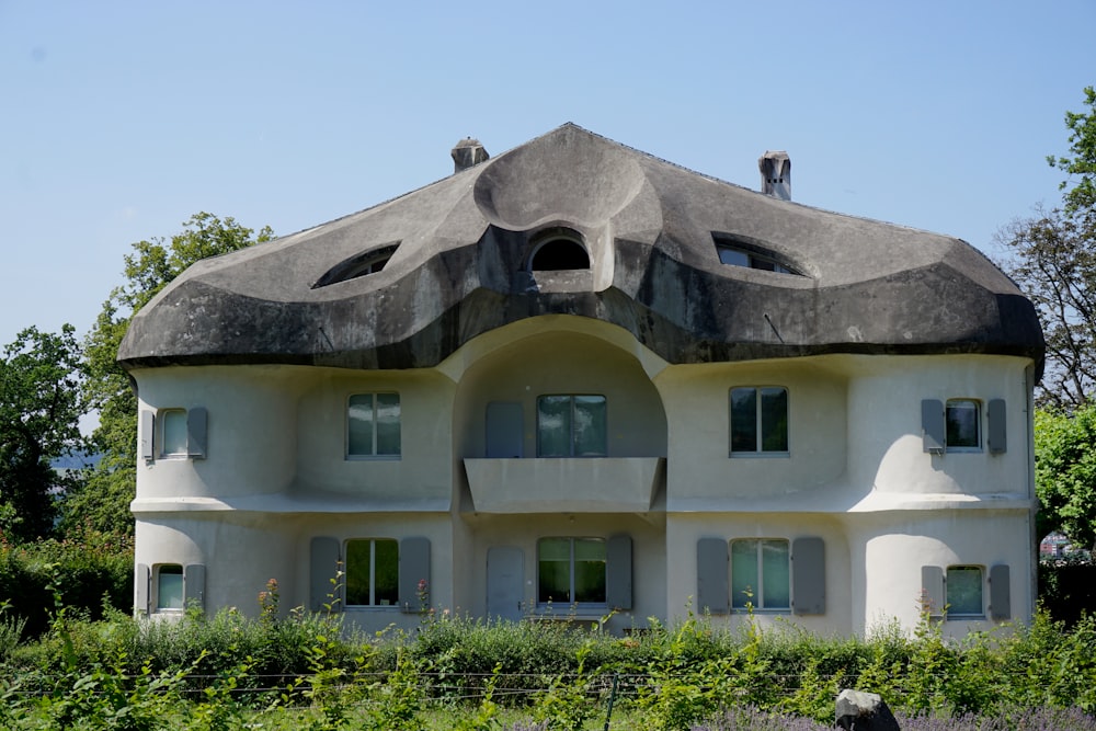 white concrete building near green trees during daytime