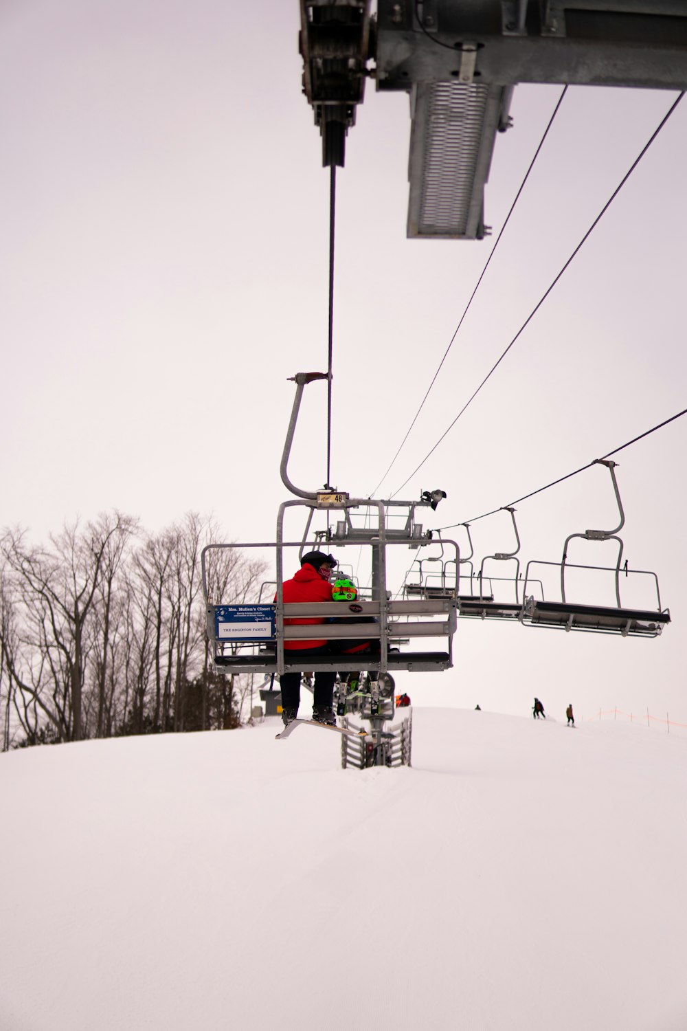 red cable car over snow covered ground during daytime