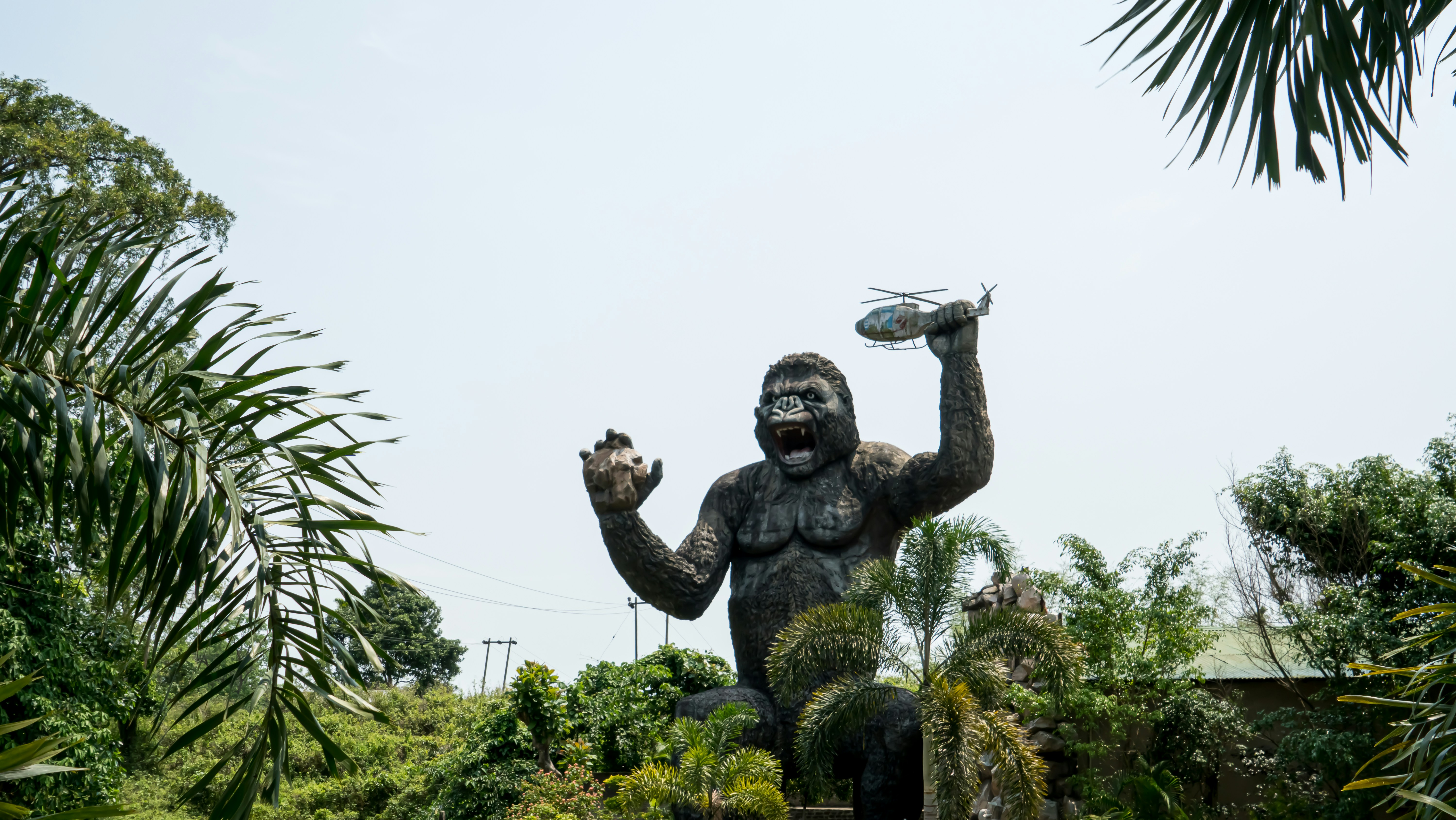Man with wings statue near green trees during daytime photo Free Blue Image on Unsplash