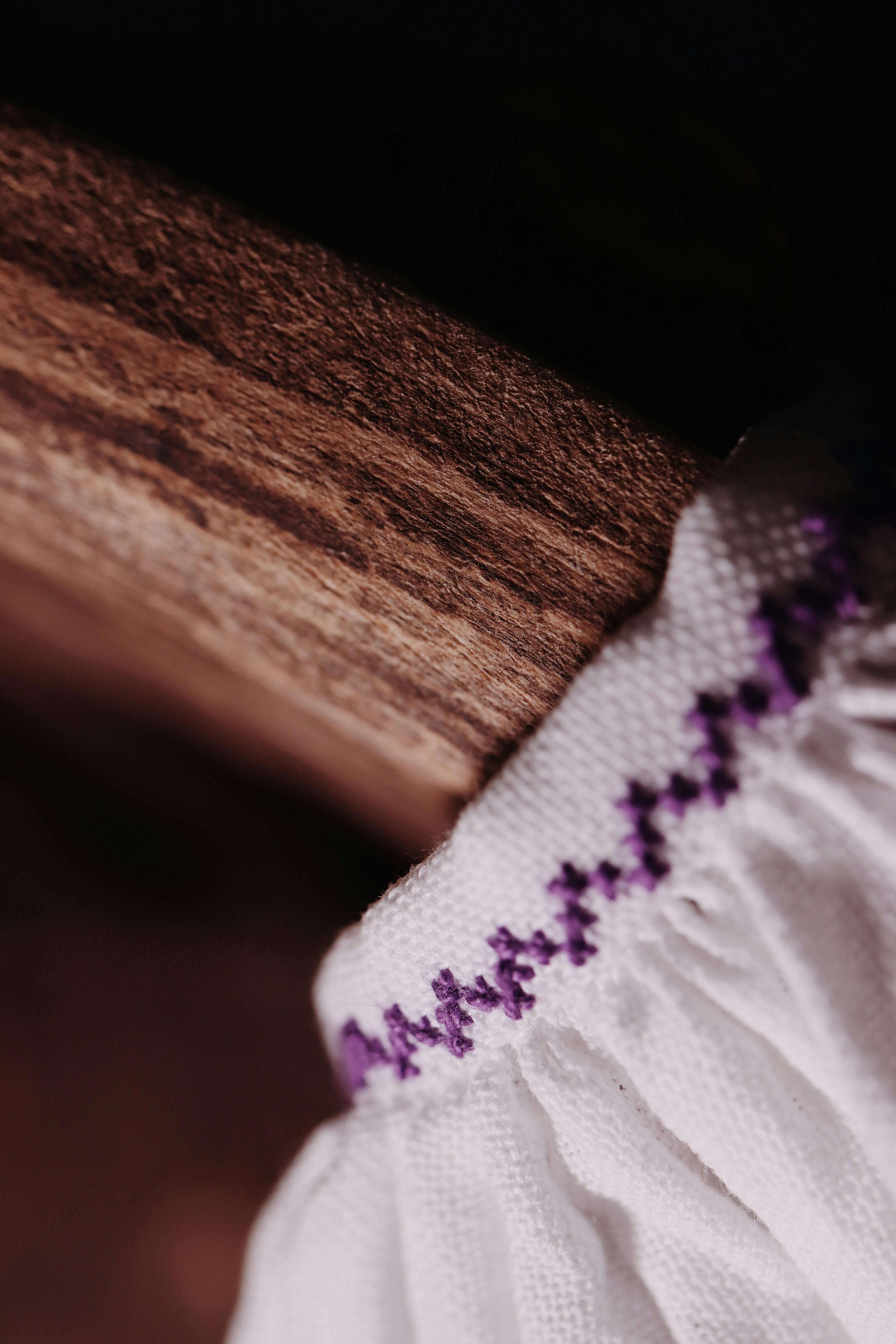 white and purple textile on brown wooden table