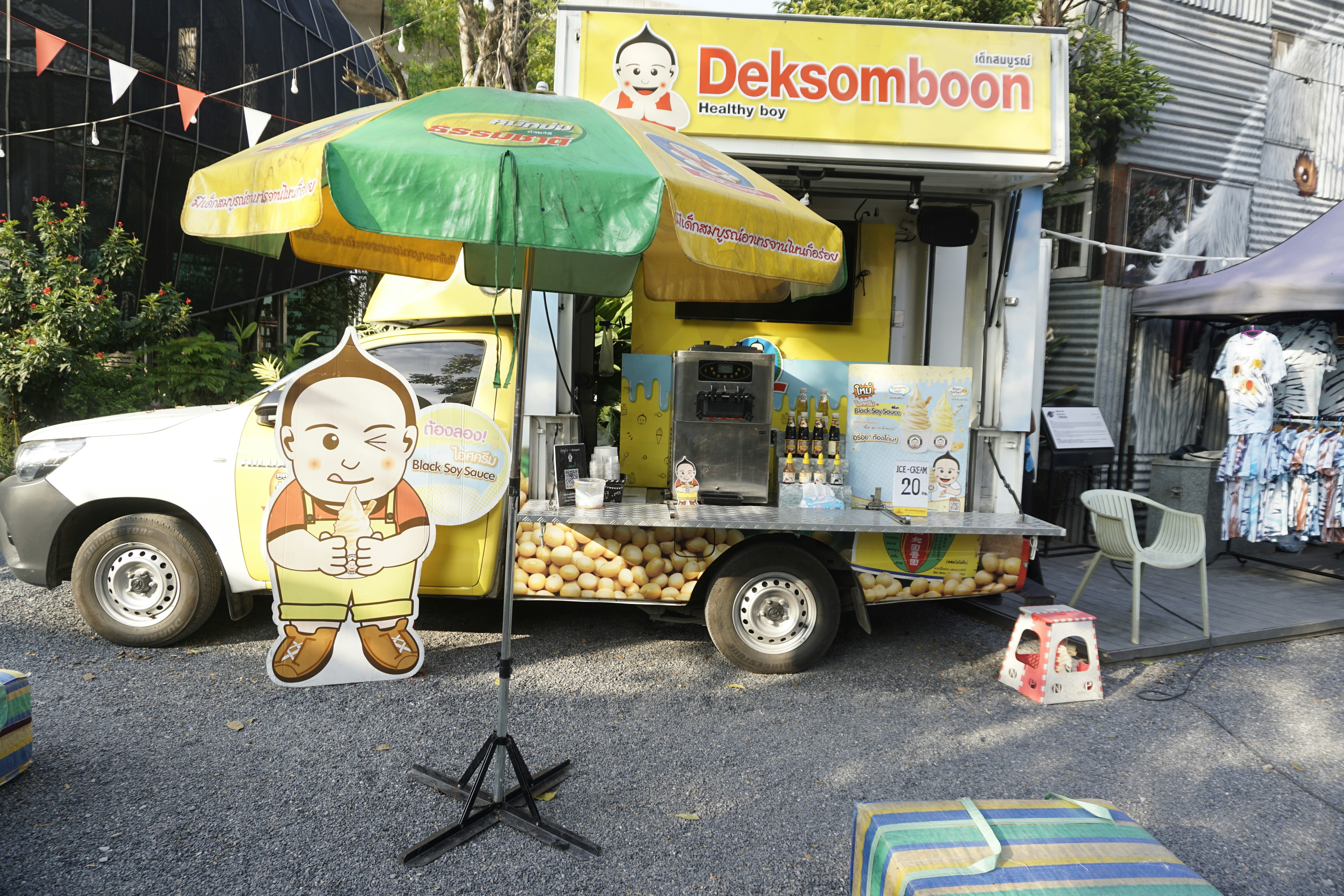 yellow and green food cart near white and brown dog statue