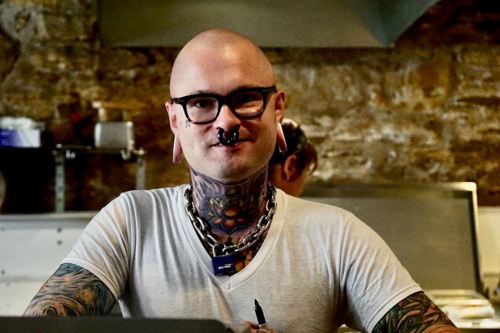 man in white crew neck t-shirt wearing black framed eyeglasses