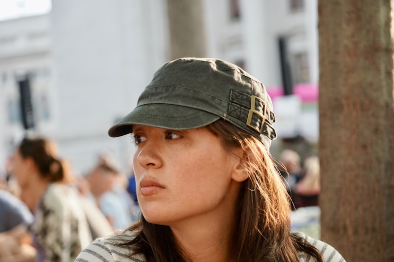 woman in green and black camouflage cap