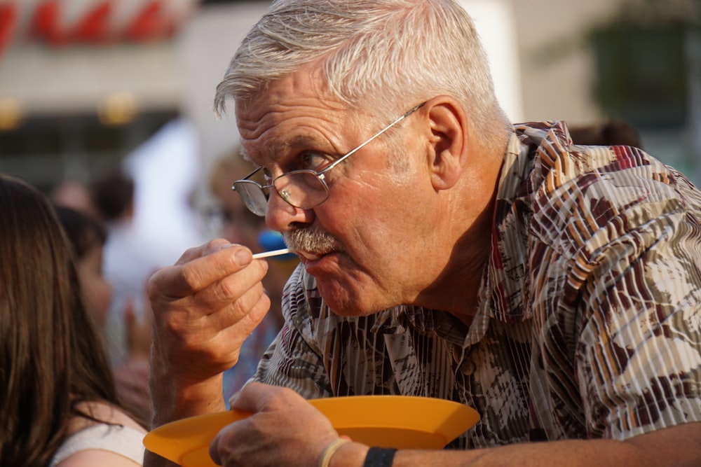 man in brown and black plaid button up shirt smoking cigarette