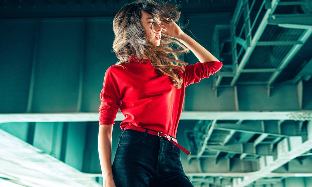 woman in red long sleeve shirt and blue denim jeans