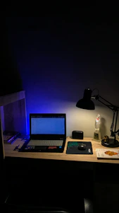 A warm, inviting desk setup with an open laptop displaying fact-checked articles and a glowing lamp symbolizing clarity.