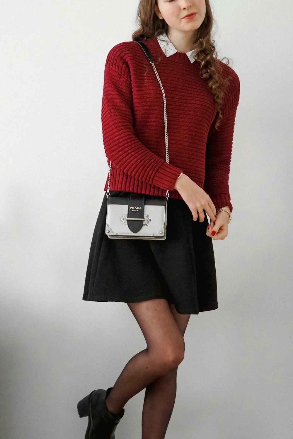 woman in red long sleeve shirt and black skirt