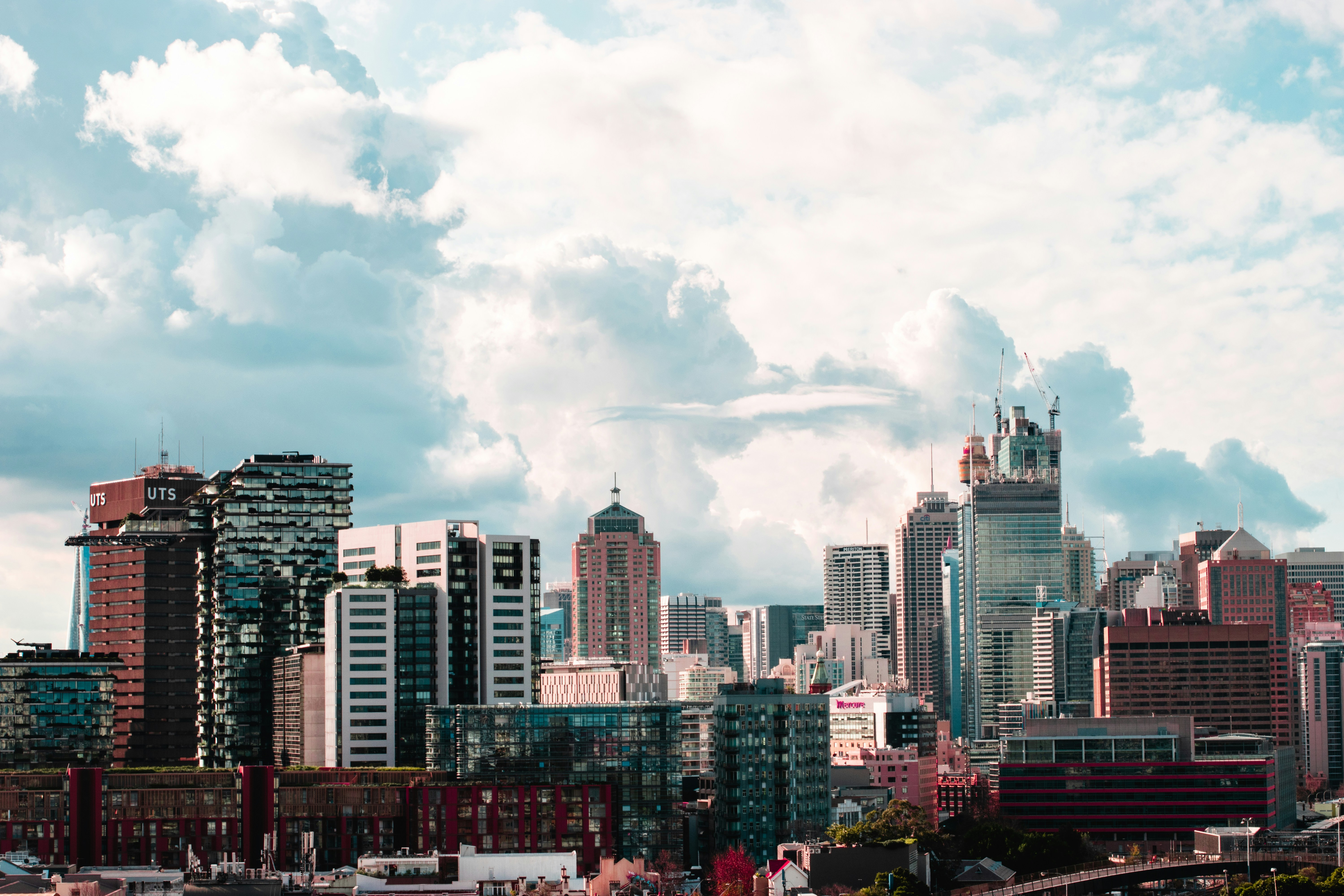 city skyline under white clouds during daytime