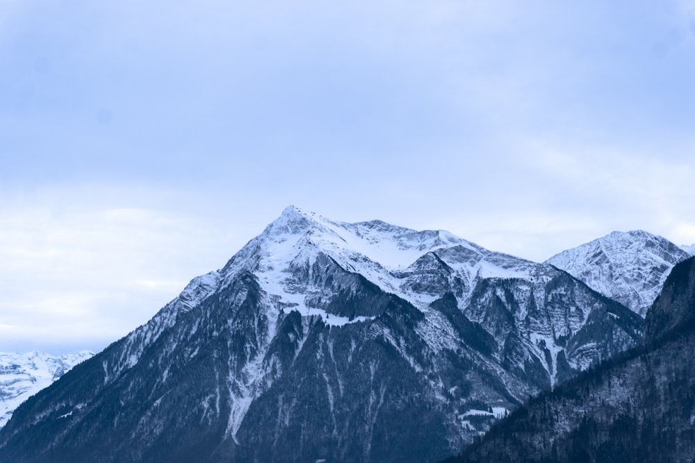 snow covered mountain under cloudy sky during daytime